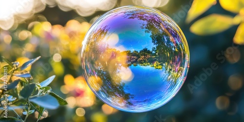 A vibrant, colorful bubble floating in a natural setting with trees and leaves in the background.