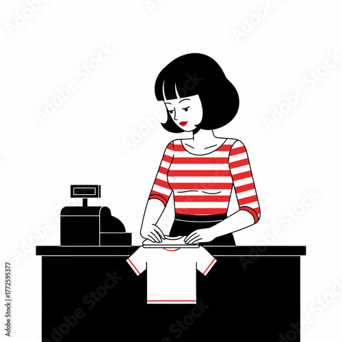 Cashier neatly folding a small white t-shirt at a checkout counter.