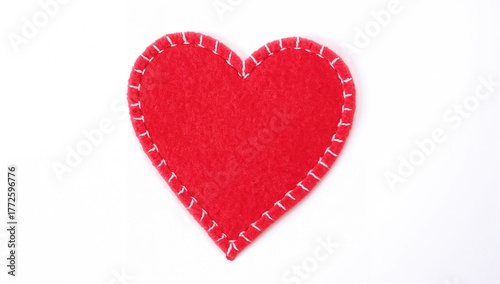 White stitched red felt heart symbolizing handmade love on a plain background. Decorative piece for romantic designs such as invitations and covers.