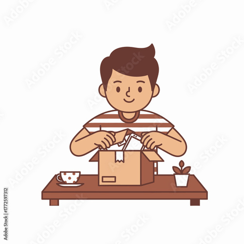 Young man happily unboxing a package on a table.