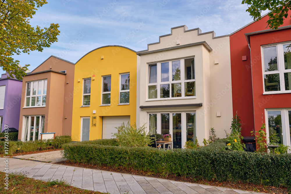 Fototapeta premium Colorful modern row houses with clean lines and bright facades in Wismar, Germany, highlighting minimalistic architecture and sustainable urban housing
