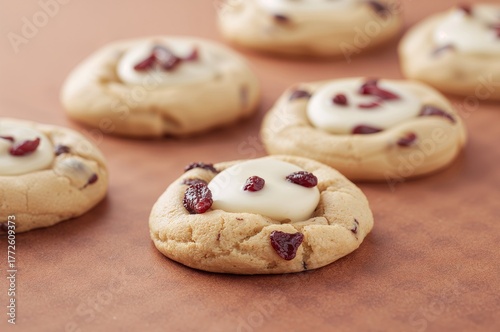 Delicious cranberry and white chocolate cookies arranged on a patterned surface