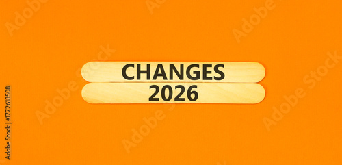 Changes 2026 symbol. Concept words Changes 2026 on beautiful wooden sticks. Beautiful orange paper background. Business and changes 2026 concept. Copy space.