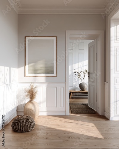 A white room with a white door and a picture on the wall