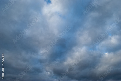 the blue sky shines through the dark clouds