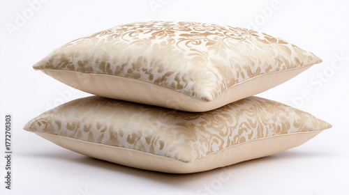 Beige damask-patterned pillows stacked, isolated on white background