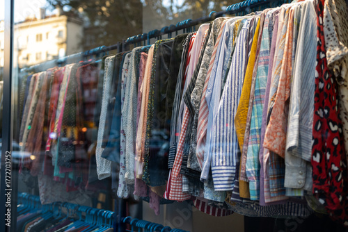 Clothing store window display. Clothing on a rack. Second hand shop window display