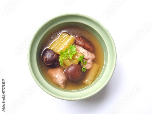 Chinese bitter melon soup with chicken and shiitake mushrooms in clear broth, topped with fresh cilantro. Light, savory, and beautifully presented in a green bowl.