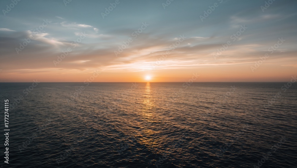 Fototapeta premium Stunning sunset over the ocean with vibrant sky and natural beauty
