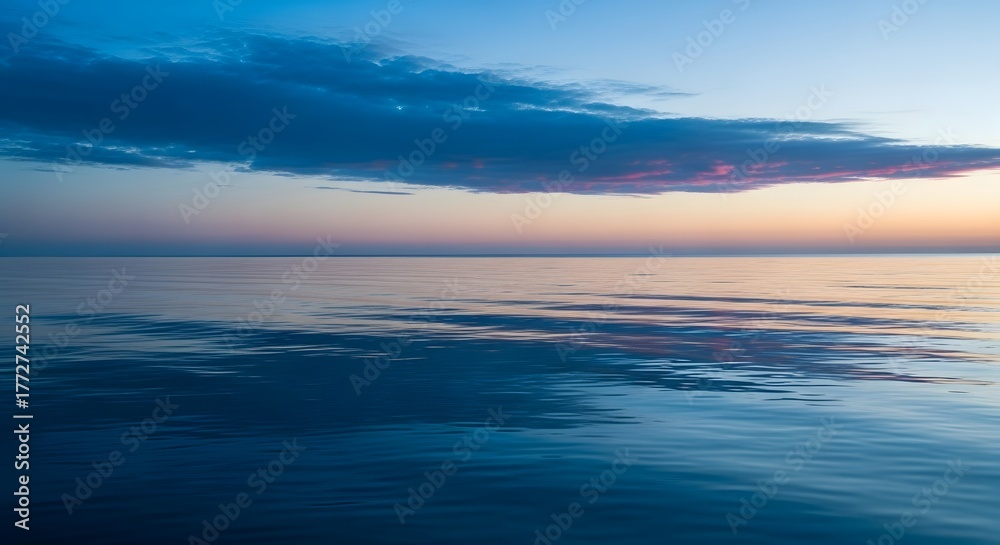 Fototapeta premium Tranquil ocean scene with soft waves and vibrant sunset colors reflecting on the water surface, symbolizing relaxation, calmness, and natural beauty.