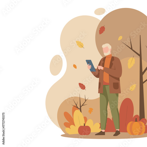 Senior man using a tablet outdoors during autumn Technology and digital communication concept