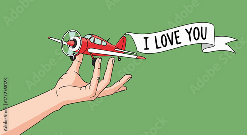 Whimsical declaration of love: Red airplane with banner held gently on a human hand