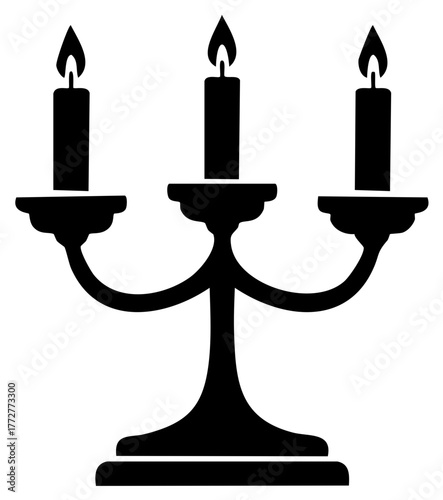 Elegant three arm candelabra with burning candles in black silhouette providing warm light symbol of celebration