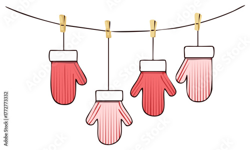 Pink winter mittens hanging on a clothesline with clothespins