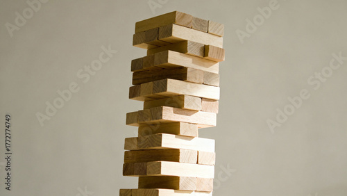 A tall, tilted tower of assorted wooden blocks against a plain background. real-estate listings, architecture portfolios, designed for interior renovation comparisons for interiors.
