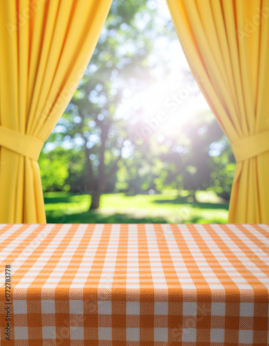 Empty Table with Orange Checkered Tablecloth by Sunny Garden Window for Product Display