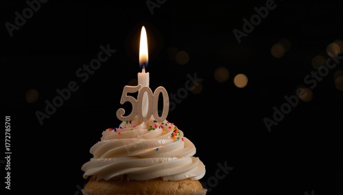 Cupcake topped with a 500-s...