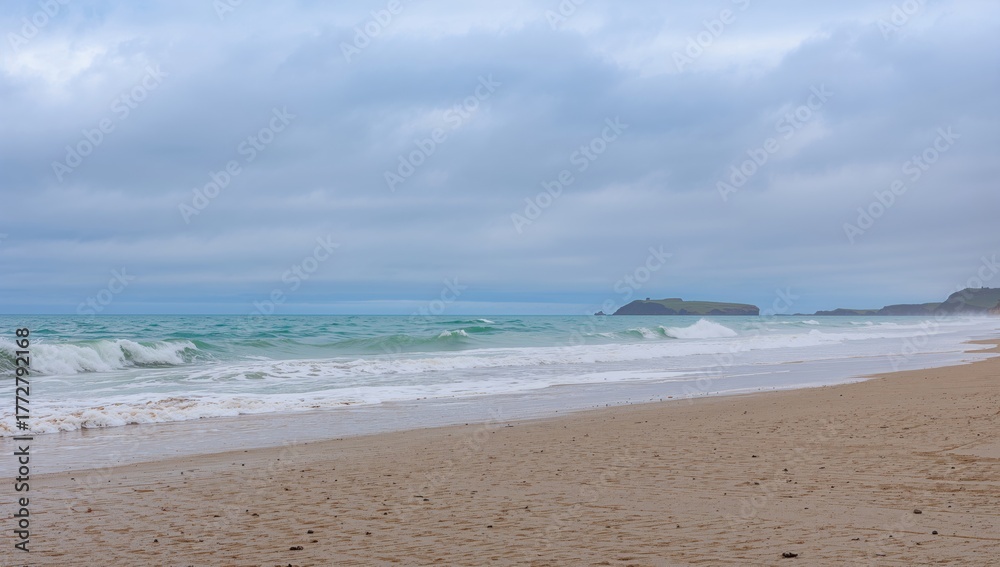 Fototapeta premium Majestic ocean waves crashing onto the beach beneath a cloudy sky, erosion risk