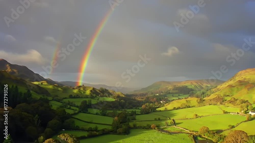 Rainbow Arcs Over Rolling Hills Landscape Aerial View