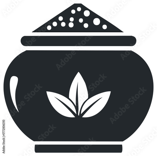 Stylized dark jar with leaves motif and granular content