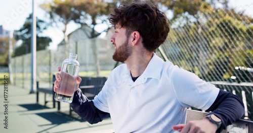 Man, tennis player and drinking water with bottle on bench for rest, break or recovery. Active, male person or relax with mineral liquid, thirst or beverage for sports, hydration or sustainability