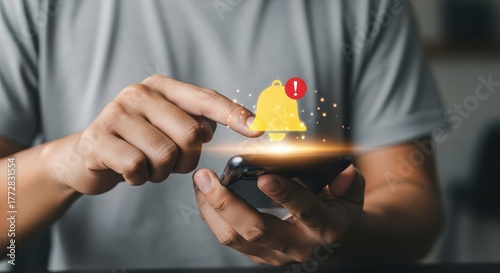 Notification bell icon on smartphone screen with finger touch