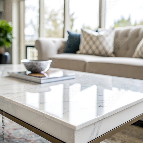 A bright living room featuring a marble coffee table with a bowl and a sofa in the background
