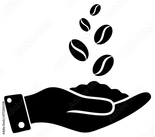 Black silhouette of a hand catching falling coffee beans a symbol of harvest and production process