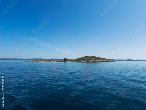 Seascape with Distant Rocky Island under Clear Blue Sky