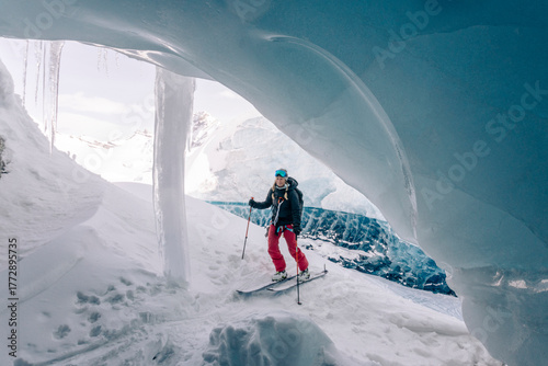 A group of skiers explore the large ice caves in the Northern Rockies of British Columbia, Canada.