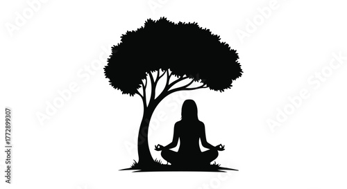 Silhouette of a woman meditating peacefully under a large tree in nature