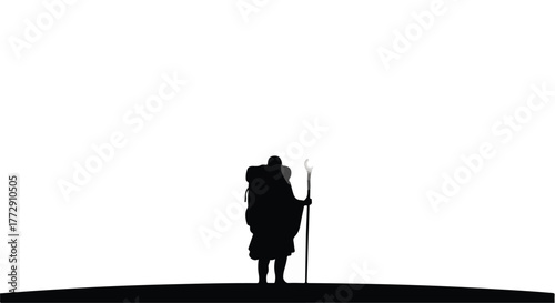 Solitary traveler with backpack and staff journeys across a stark landscape under a bright sky.