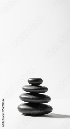 Zen balance stones stacked neatly on white background, calm and wellness concept, minimalist style
