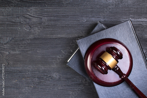 Law concept - Open law book with a wooden judges gavel on table in a courtroom or law enforcement office isolated on white background. top view.