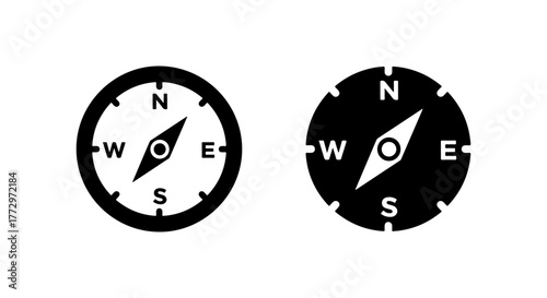 Two compass icons one white and one black showing direction