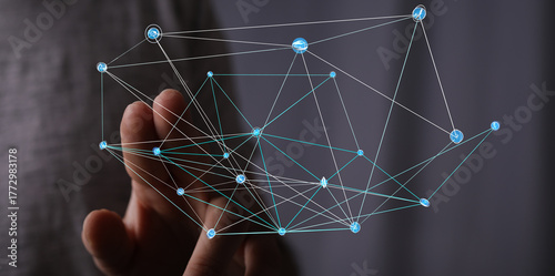 A hand interacting with a digital network visualization, representing connections, technology, communication, and global networks. Concepts of i