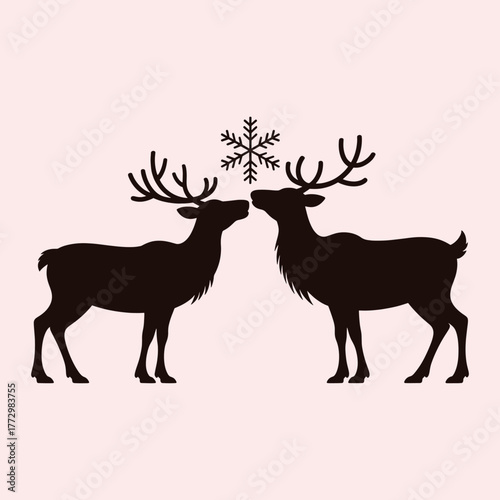 Two dark brown reindeer silhouettes facing each other with a snowflake above them on a pale pink background