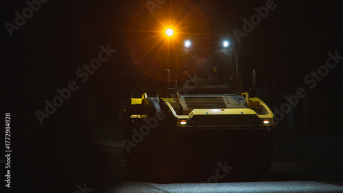 desolate street scene with maintenance vehicle preparing for overnight repairs under moody lighting