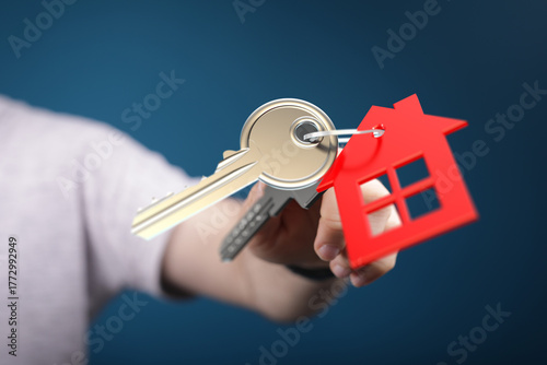 A person holds house keys w...