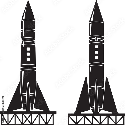 Two vintage style rockets silhouetted on launch pads against white background
