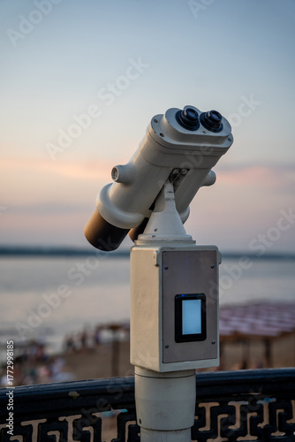 Coin operated binoculars at sunset by the water