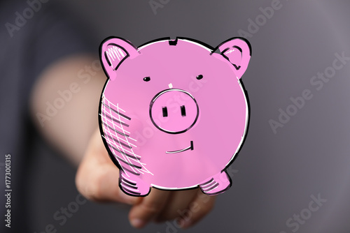 Hand holding a pink piggy b...