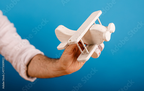 A hand is holding a small, ...
