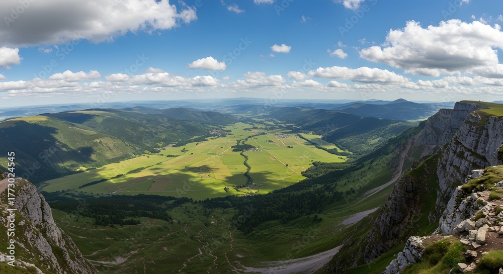 Obraz premium The panoramic expanse of a valley from a mountain ledge.