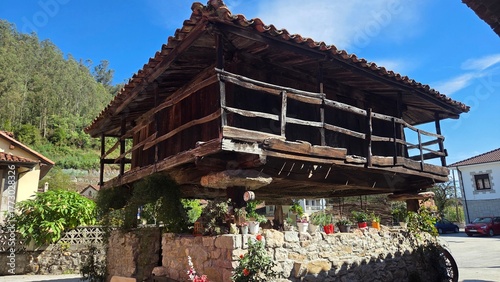 Traditional spanish horreo in Bueño village with rustic architecture under blue sky. Asturias