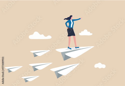 Business leadership, woman power to lead company to achieve target, smart confidence businesswoman standing on leading flying paper airplane origami pointing finger to the direction to reach goal.