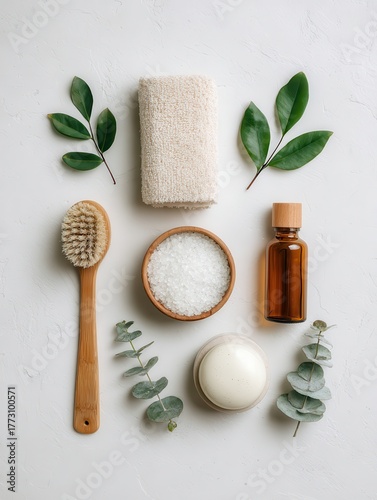 Flat lay of eco-friendly beauty products, natural textures and leaves on a white background with space for copy text