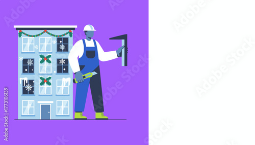 Worker in hard hat does winter maintenance on a building decorated for Christmas