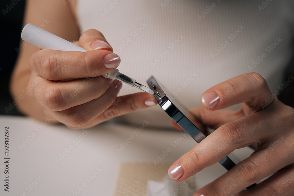 Ταπετσαρία Close-up cropped shot of woman cleaning microphone of smartphone with specialized brush tool, focusing on maintaining optimal audio quality and ensuring hygiene for better communication