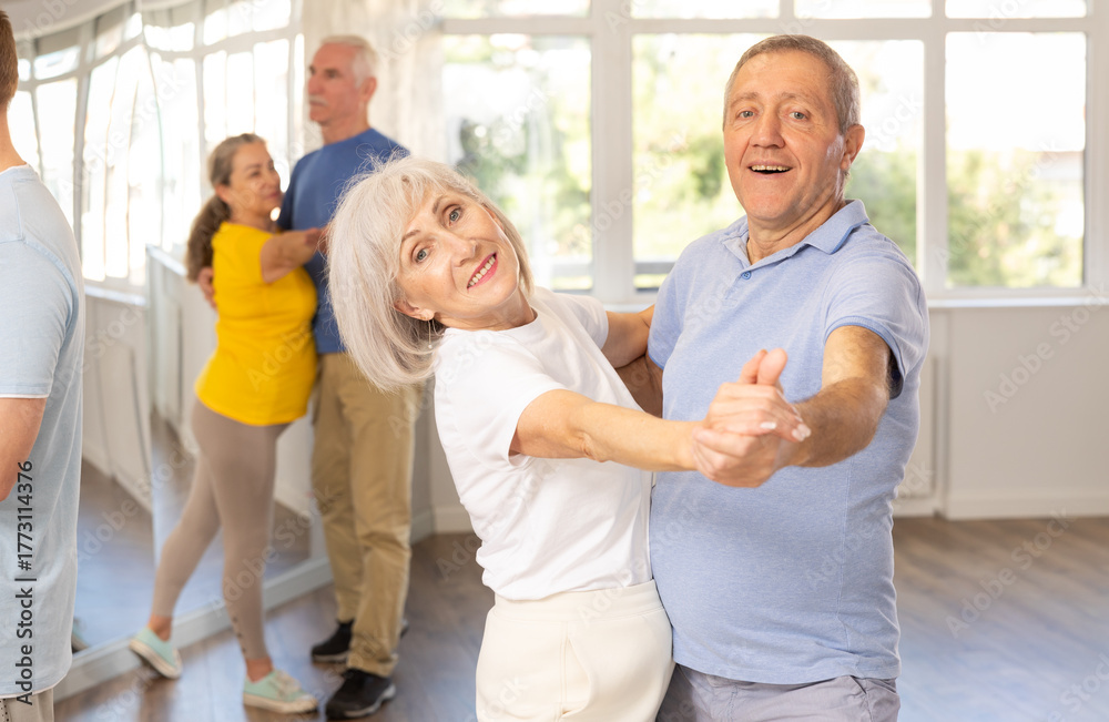 Fototapeta premium Elderly man and elderly woman dance ballroom dance waltz in studio
